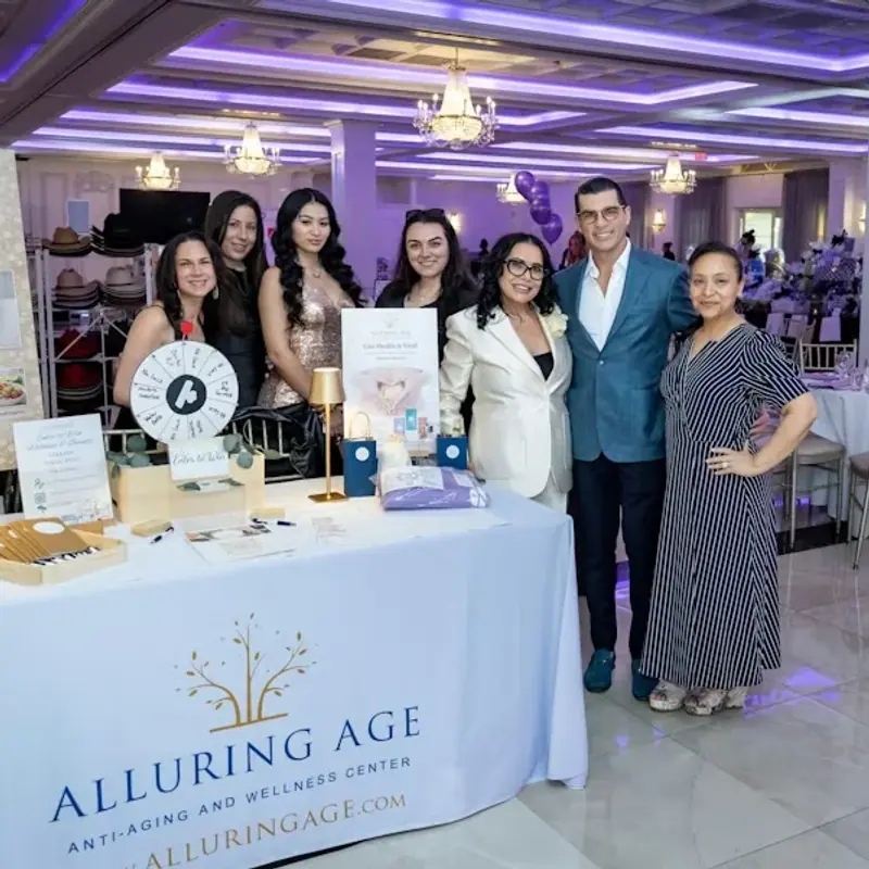 The Alluring Age team with Dr. Luis Fandos at their wellness activation table during the 9th Annual Beauty Ball at Villa Lombardi's