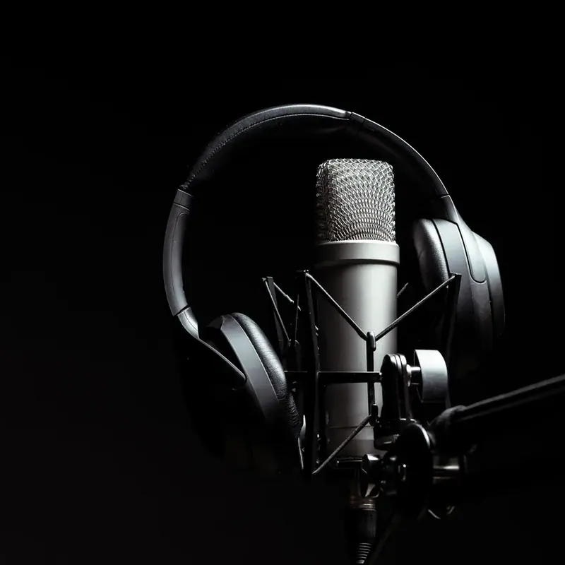 A studio microphone and headphones