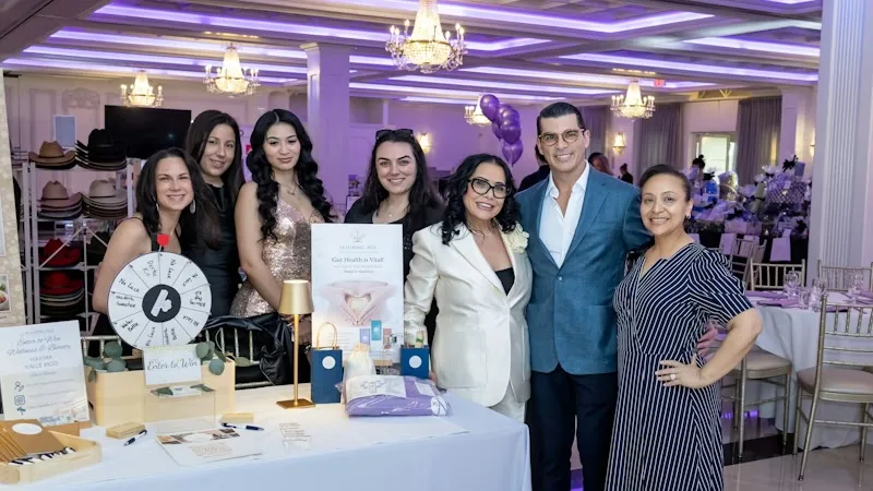 The Alluring Age team gathered at their activation table in the Villa Lombardi's ballroom, with the prize wheel and wellness giveaways set out