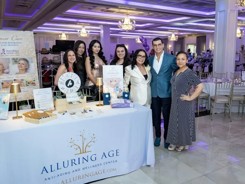 The Alluring Age team with Dr. Luis Fandos at their wellness activation table during the 9th Annual Beauty Ball at Villa Lombardi's